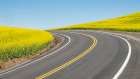 Road splitting canola field with matching yellow center stripe Art Print